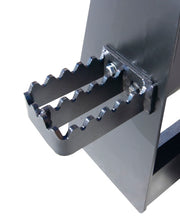 Close view of the bolt-on step fitted to an Arrow heavy duty skid steer fork frame, with a serrated open-grid tread and two bolts through the upright