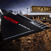 Arrow skid steer bucket side plate carrying the red Arrow Material Handling Products decal, shown fitted with optional bolt-on teeth against a construction site background