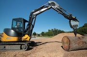 Deere 50D excavator holding the RSX380 above a log in a chip yard