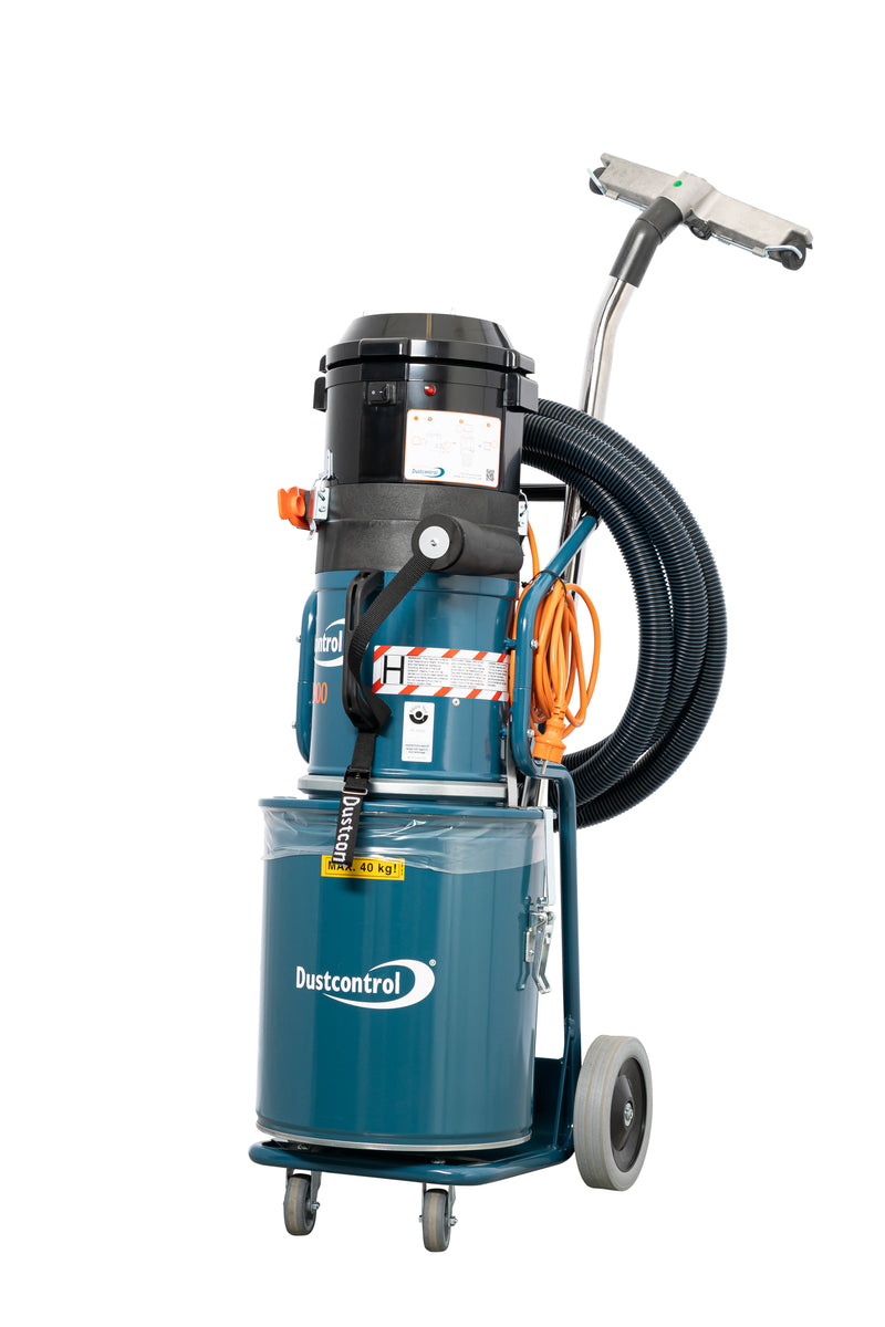 Dustcontrol DC 2900 H a dust extractor with a teal steel collection container, coiled hose and aluminium floor tool on a chrome suction pipe