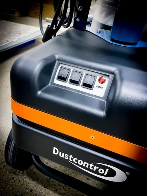 Close view of the DC Tromb 600 motor housing showing the rocker switch panel and the red filter indicator lamp