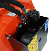 Close-up of the black hydraulic drive motor bolted to the end of the Hurricane mini mixer drum, with sleeved hoses and the safety decal panel, against a white background