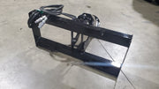 Glacier auger drive from the rear on a shop floor, showing the open frame, coupler ends, and hose routing