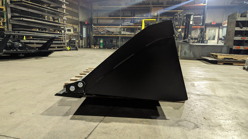 Glacier Extreme general-purpose bucket, side profile on a shop floor showing the tapered side plate