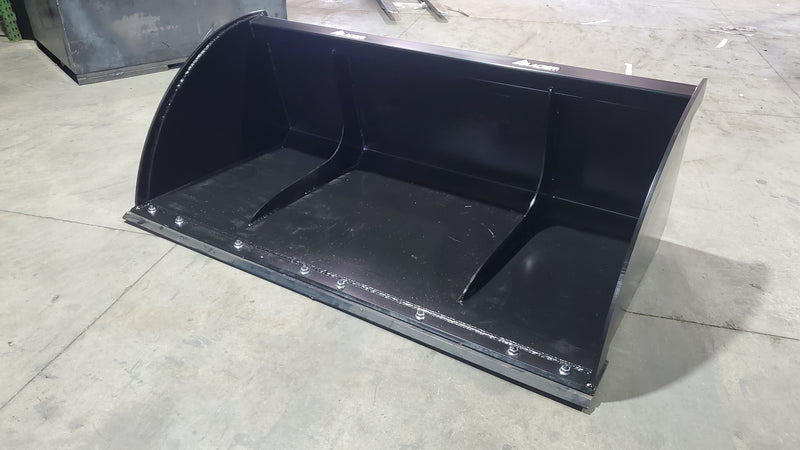 Glacier Extreme high-capacity material bucket, low angled view across the bolt-on cutting edge and the interior gussets