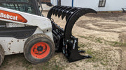 Glacier Extreme rake and brush grapple on a Bobcat skid steer, side view with the grapple arms raised