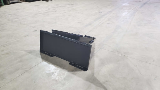 Glacier Extreme stump bucket on a shop floor, rear view showing the quick-attach mounting plate and narrow profile