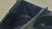 Glacier Extreme stump bucket, close view of the reinforced interior, gussets, and serrated top edge