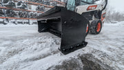 Glacier HD snow pusher on a white skid steer in snow, angled view of the boxed moldboard