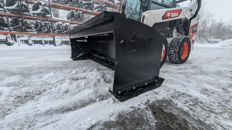 Glacier HD snow pusher on a white skid steer in snow, angled view of the boxed moldboard