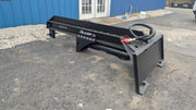 Glacier log splitter on pavement outside a blue building, three-quarter view showing the quick-attach plate and hose coupler