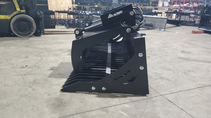 Glacier rock and brush grapple in a warehouse, angled view with the spiked tines facing forward