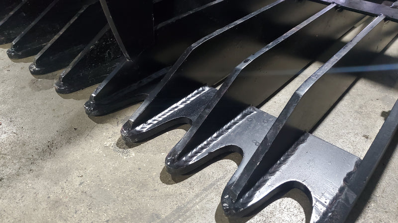 Glacier rock and brush grapple, close view of the forged tine tips along the lower bar