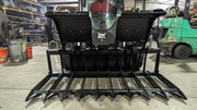 Glacier root and brush grapple mounted on a skid steer, head-on view across the full width of the thick tines