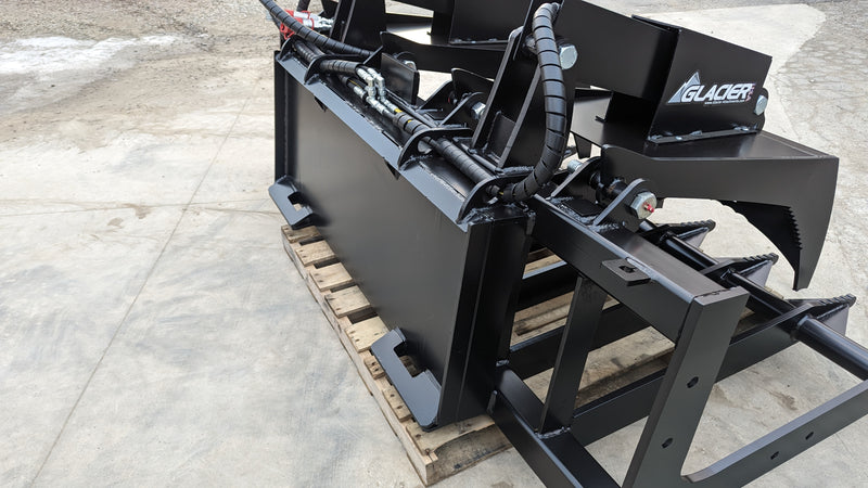 Glacier root and brush grapple, close angled view of the grapple arm serrations and the cylinder rod