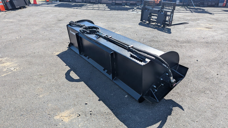 Glacier rotary tiller on pavement, three-quarter view showing the rotor housing and mounting frame