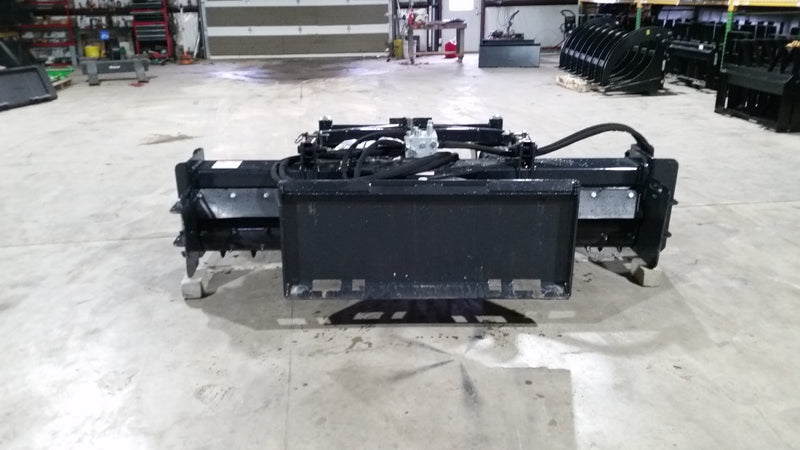 Glacier soil conditioner head-on in a shop, showing the full working width, drum ends, and quick-attach plate