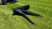 Glacier Extreme Stump Shark on grass beside a track loader, three-quarter view of the teeth and frame