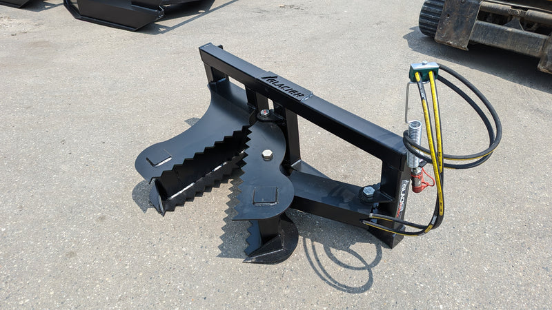 Glacier tree puller on pavement, three-quarter view showing the serrated jaws, cylinder, and hose
