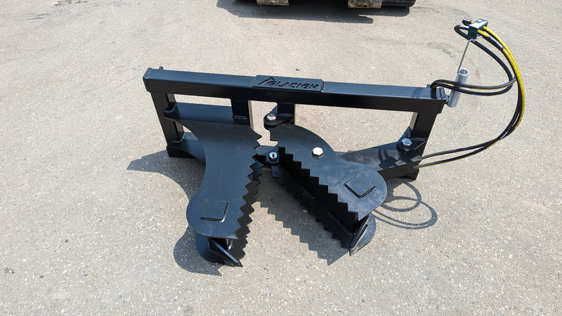 Glacier tree puller on pavement from above, showing both serrated clamping edges and the frame