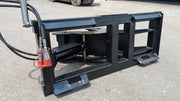 Glacier tree puller from the rear on pavement, showing the frame, cylinder, hose coupler, and quick-attach lugs