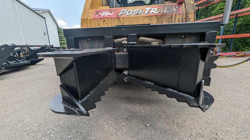 Glacier tree puller on an ASV track loader, head-on view of the two serrated jaws closed together
