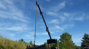 Glacier truss boom raised against the sky, side view of the extended boom sections and the hanging chain