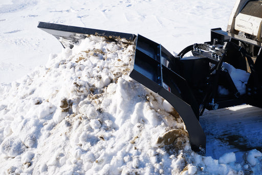 HitchDoc V-Blade in the scoop position on a skid steer, high three-quarter view showing both wings, the blade extensions along the top edge and the hydraulic hose block at the mount