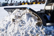 HitchDoc V-Blade in the scoop position holding snow, side view in an equipment yard with the two wings and their blade extensions clearly separated