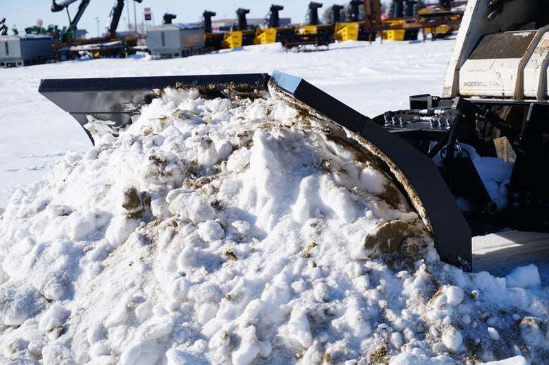 HitchDoc V-Blade in the scoop position holding snow, side view in an equipment yard with the two wings and their blade extensions clearly separated