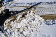 HitchDoc V-Blade angled and windrowing snow to the left, close side view of the moldboard face and the top blade extension