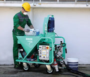 IMER Koine Dual continuous mortar pump, breaking a bag of material into the hopper on site