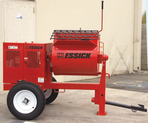 Multiquip Essick EM70S mortar mixer parked on a concrete yard against a pale stucco wall, a red towable machine with a black safety grate over the drum mouth, the MQ Multiquip mark and the Essick name in black on the drum side and again on a vented engine enclosure, a red dump lever with a black grip standing upright at the drum, road wheels on white five lug rims, and a black tow bar with a ball coupler beside a red jack leg on a footplate