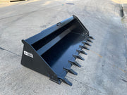 Extreme duty skid steer bucket with teeth seen from the front quarter on pavement