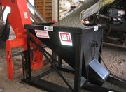 Concrete hopper being charged from a mixer truck chute on site