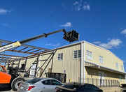 Trash hopper on the boom over the same roof, seen from the ground