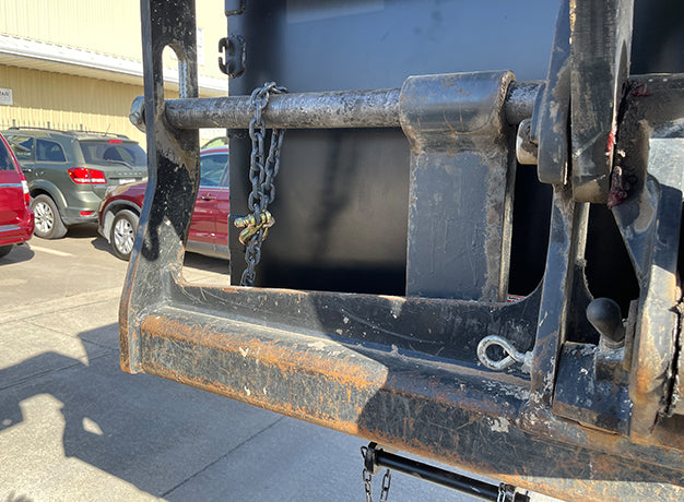Fork pocket rail and safety chain where the hopper meets the carriage