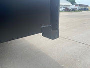 Base corner of the trash hopper showing the foot and the plate joint