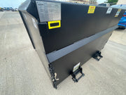 Trash hopper in the yard with its data plate and capacity markings on the side