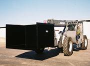 Telehandler holding the trash hopper alongside, seen from the side