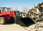 Telehandler working with the forklift bucket in a demolition yard