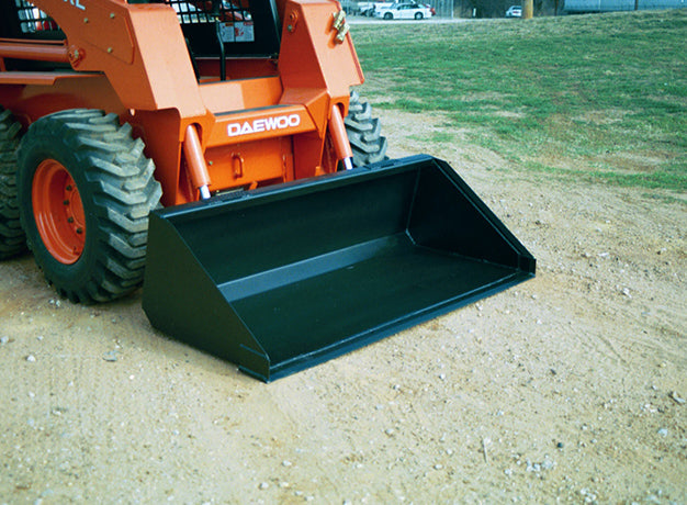 Heavy duty skid steer bucket mounted on an orange skid steer on grass, plain edge