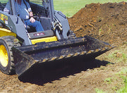 Toothed heavy duty bucket loading soil from a bank on a landscaping job