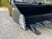 Heavy duty skid steer bucket on a machine with bolt-on side cutters fitted at the corner