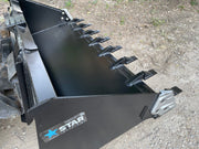 Toothed heavy duty skid steer bucket on the ground with the Star Industries badge on the side plate