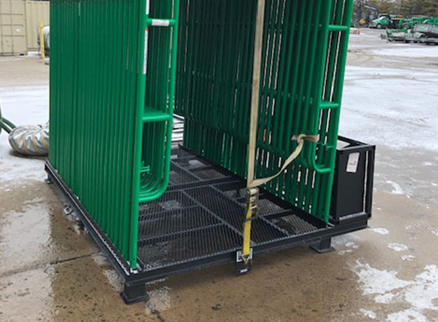 Loaded scaffold pallet with a ratchet strap over the frames through the anchor points