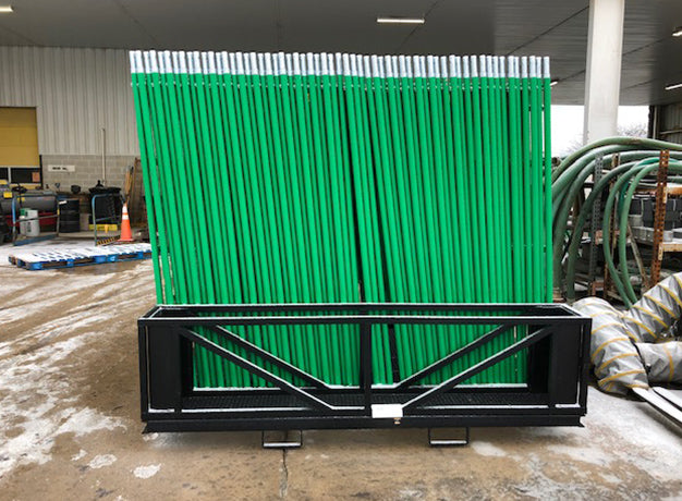 Loaded scaffold pallet standing under cover in a rental yard