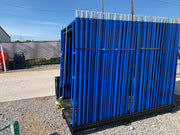 Scaffold pallet loaded with blue frames standing on a gravel yard