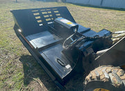 Brush cutter deck from above showing the top plate, the motor housing and the hose bundle to the loader