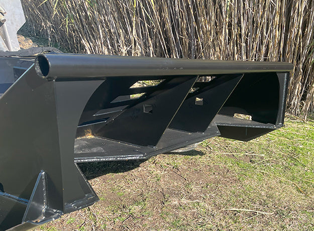 Looking into the open front of the brush cutter deck at the push bar and the reinforced side